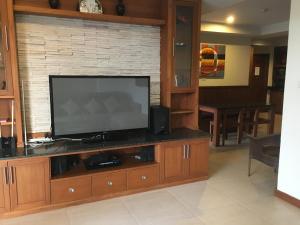 a living room with a flat screen tv on a entertainment center at Khanom Beach Residence Monthly Rental Condo in Khanom