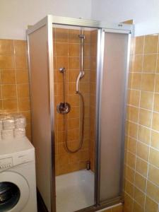 a shower in a bathroom with a glass door at Pension Wallnöfer in Mieming