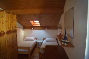 a small room with two beds and a table at Apartments Tonka Grebaštica in Grebaštica