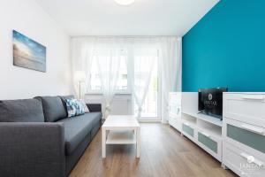 Televízia a/alebo spoločenská miestnosť v ubytovaní Jantar Apartamenty Bliżej Morza