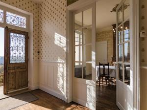 a hallway with a door and a dining room at Mansion with Private Pool in Aquitaine in Savignac-Lédrier