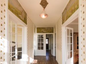 a hallway with white walls and a ceiling with paintings at Mansion with Private Pool in Aquitaine in Savignac-Lédrier