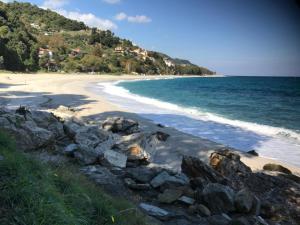 a view of a beach with rocks and the ocean at Aegean Sunset in Damouchari +29 photos