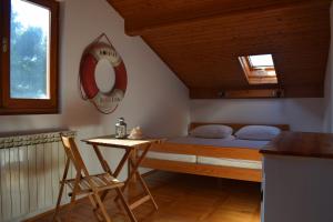 a bedroom with a bed and a desk and a mirror at Apartments Tonka Grebaštica in Grebaštica