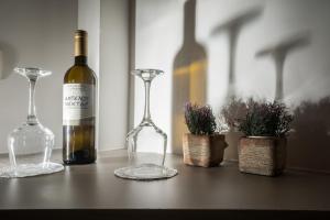 a bottle of wine and two glasses on a table at Cretan Berry Portou in Chania