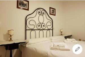 a bedroom with a bed with a metal head board at Biennale Palace close to Piazza San Marco in Venice