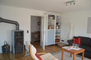 a living room with a couch and a wood stove at Ferienwohnung Platzek in Schneverdingen