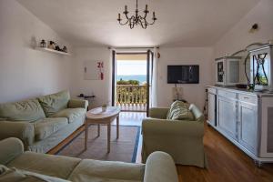 a living room with a couch and a table at Apartments Petrčane Welcome in Petrcane