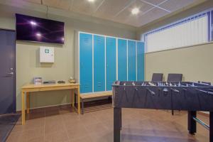 a room with blue lockers and a ping pong table at Vae 22 Residence in Laagri