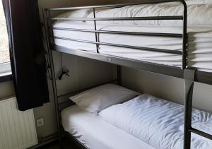 a couple of bunk beds with a pillow on them at Hvammstangi Hostel in Hvammstangi