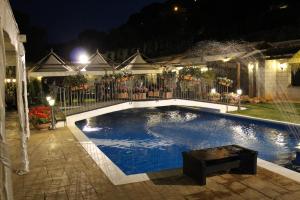 a swimming pool in a yard at night at B&B Montereale in Monreale