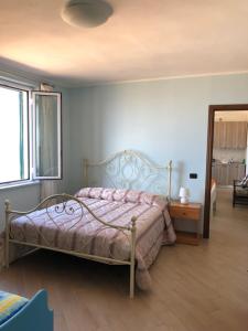a bedroom with a bed with a pink comforter at Il Terrazzo su Pizzo in Pizzo