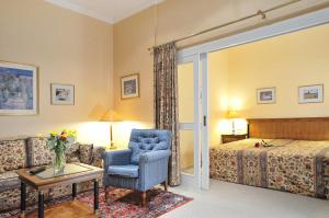 a hotel room with a couch and a chair and a bed at Hotel Residenz am Rosengarten in Bad Kissingen