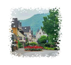 a picture of a street in a town with flowers at Pension Dören in Bruttig-Fankel