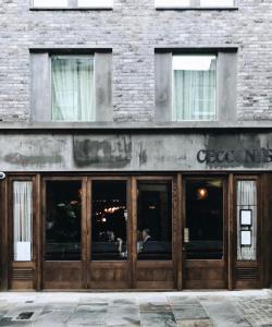 a restaurant with wooden doors on a brick building at Redchurch Townhouse in London