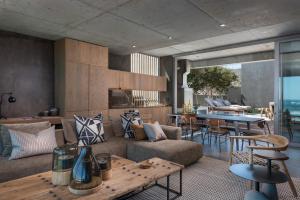 a living room with a couch and a table at The Olive Tree Villa in Yzerfontein