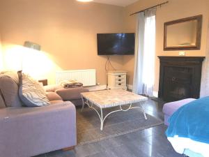 a living room with a couch and a coffee table at Ethan Cottage in Killarney