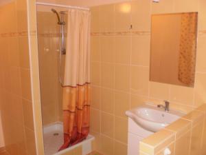 a bathroom with an orange shower curtain and a sink at Privat Buk 100 in Jindřichŭv Hradec +29 photos