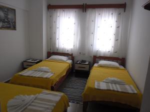 a room with two beds and two windows at Cam Hotel in Gümbet