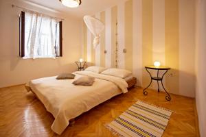 a bedroom with two beds in a room with striped walls at Apartments Petrčane Welcome in Petrcane