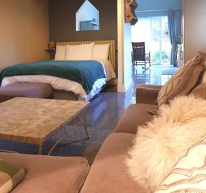 a living room with a bed and a couch at Ethan Cottage in Killarney