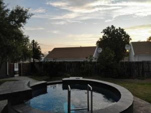 a pool in the backyard of a house at The Featherbed - Oudtshoorn in Oudtshoorn