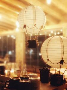 two paper lanterns sitting on top of a table at Hotel rural Finca Vivaldi Nature & Spa in San Miguel de las Dueñas