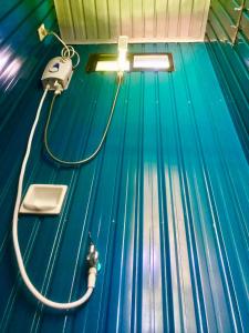 a bowling alley with a hose on a blue floor at Lanzones Cabana in Mambajao