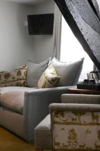 a living room with a couch and a window at The Rose and Crown in Warwick