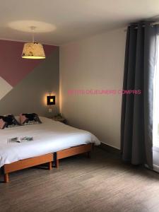 a bedroom with a bed and a window at Chambres d'Hôtes Poirier Bazin in Montry