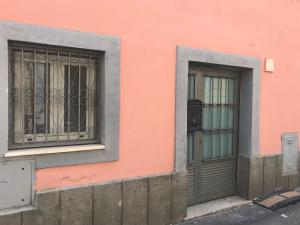 a pink building with two windows and a door at CasAphrodite in Rome