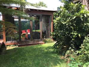 a gazebo in the yard of a house at Contemporary Stay at Giraffe Cottage in Benoni