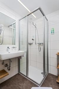 a bathroom with a shower and a sink at Hotel Unterhof in Filzmoos