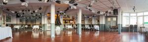a large room with tables and chairs in a room at Monterey Beach Hotel in Lytham St Annes
