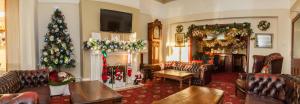 a living room decorated for christmas with a christmas tree at Monterey Beach Hotel in Lytham St Annes