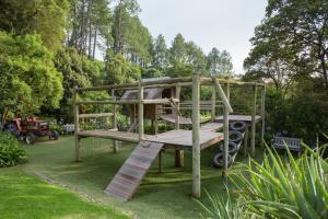 a wooden bunk bed in a garden at Cavern Resort & Spa in Bergville