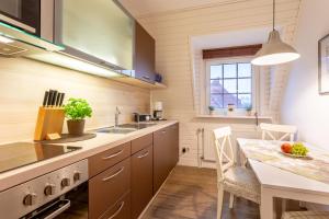 a kitchen with a table and a dining room at Ferienhaus Knippschild in Norderney