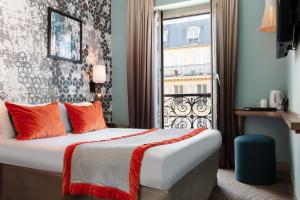 a hotel room with a bed and a window at Hotel des Nations Saint Germain in Paris