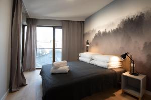 Łóżko lub łóżka w pokoju w obiekcie City Lights Rakowicka 15