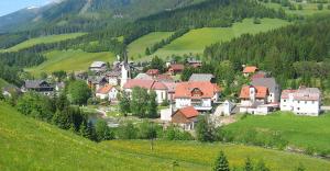 a small town in a valley with a mountain at Haus Elsasser in Sankt Johann am Tauern