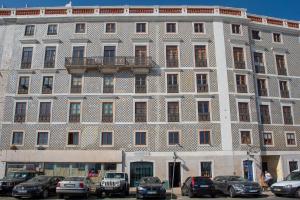a large building with cars parked in front of it at MyPlaceLisbon - Cais de Alfama Apartment in Lisbon