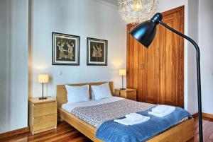 a bedroom with a bed with two towels on it at MyPlaceLisbon - Cais de Alfama Apartment in Lisbon