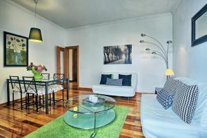 a living room with a table and a couch at MyPlaceLisbon - Cais de Alfama Apartment in Lisbon