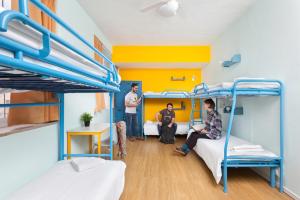 three men in a dorm room with bunk beds at Abraham Jerusalem in Jerusalem