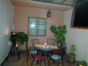 a dining room table and chairs in a room at Marrakech autrement in Marrakech