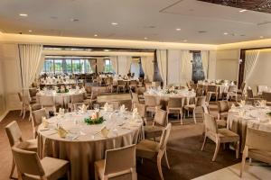 a ballroom with tables and chairs and a room filled with tables and chairsktop at Kemer Country Hotel İstanbul in Istanbul +37 photos