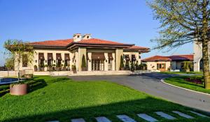 a large house with a road in front of it at Kemer Country Hotel İstanbul in Istanbul