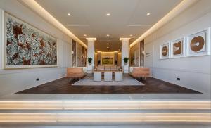 a hallway of a building with paintings on the wall at Kemer Country Hotel İstanbul in Istanbul