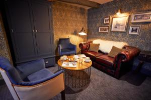 a living room with a couch and chairs and a table at The Fleece at Cirencester in Cirencester