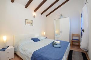 a bedroom with a large bed with a blue blanket at Villa Šeparović in Vela Luka +33 photos